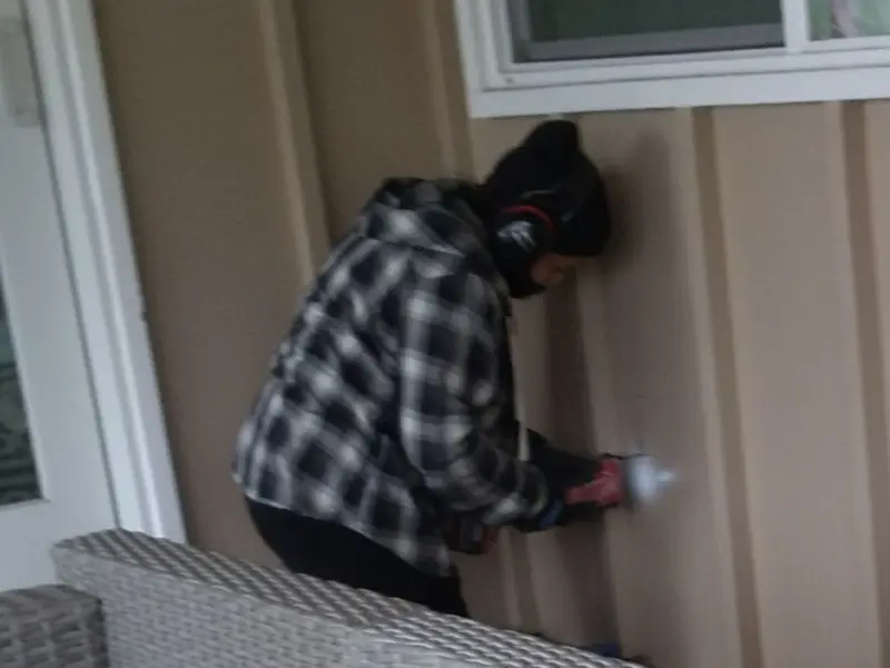 Professional electrician installing an exterior outlet in Paris