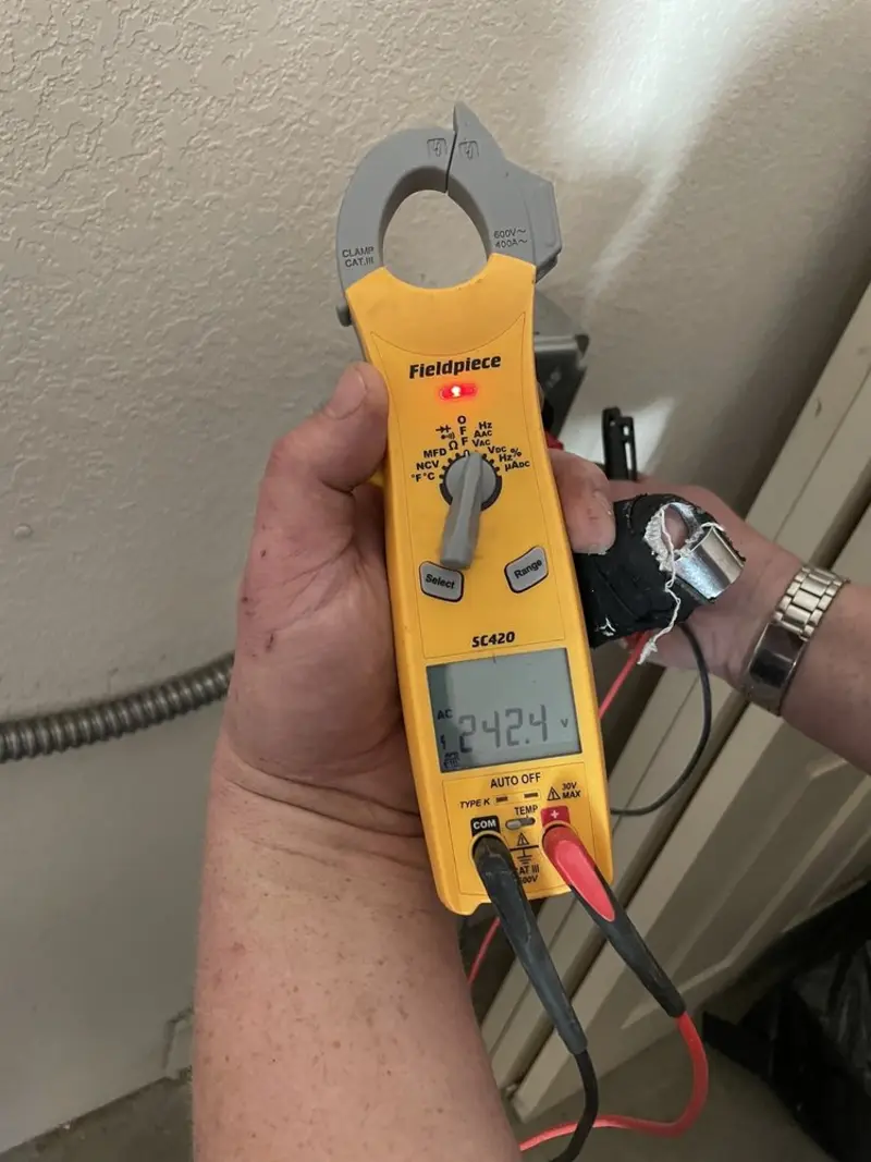 Voltage testing with clamp meter during Ceiling Fan Installation in Paris
